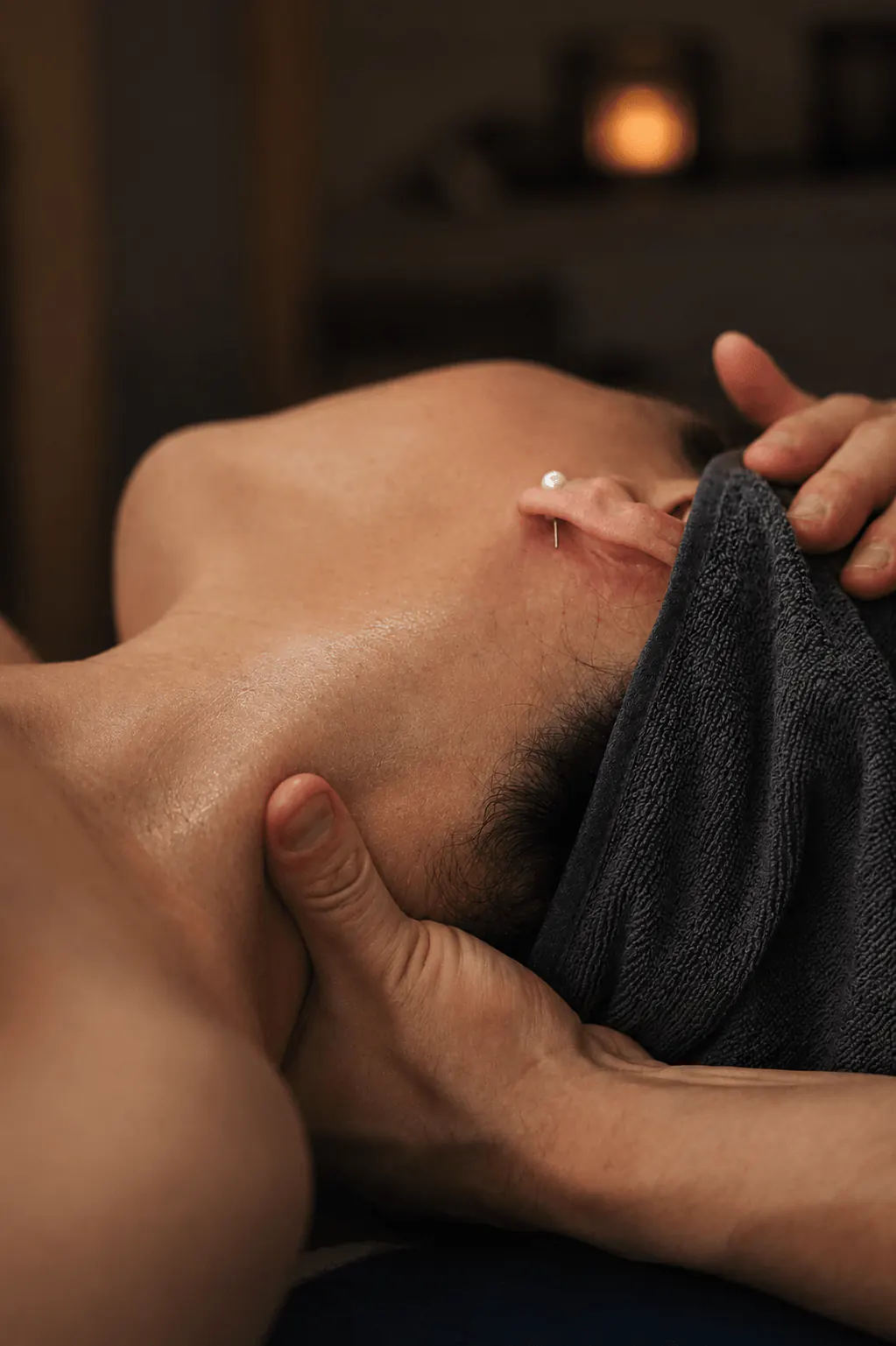 Focused neck and shoulder massage work in a calm treatment room at Muscle Movement and Improvement