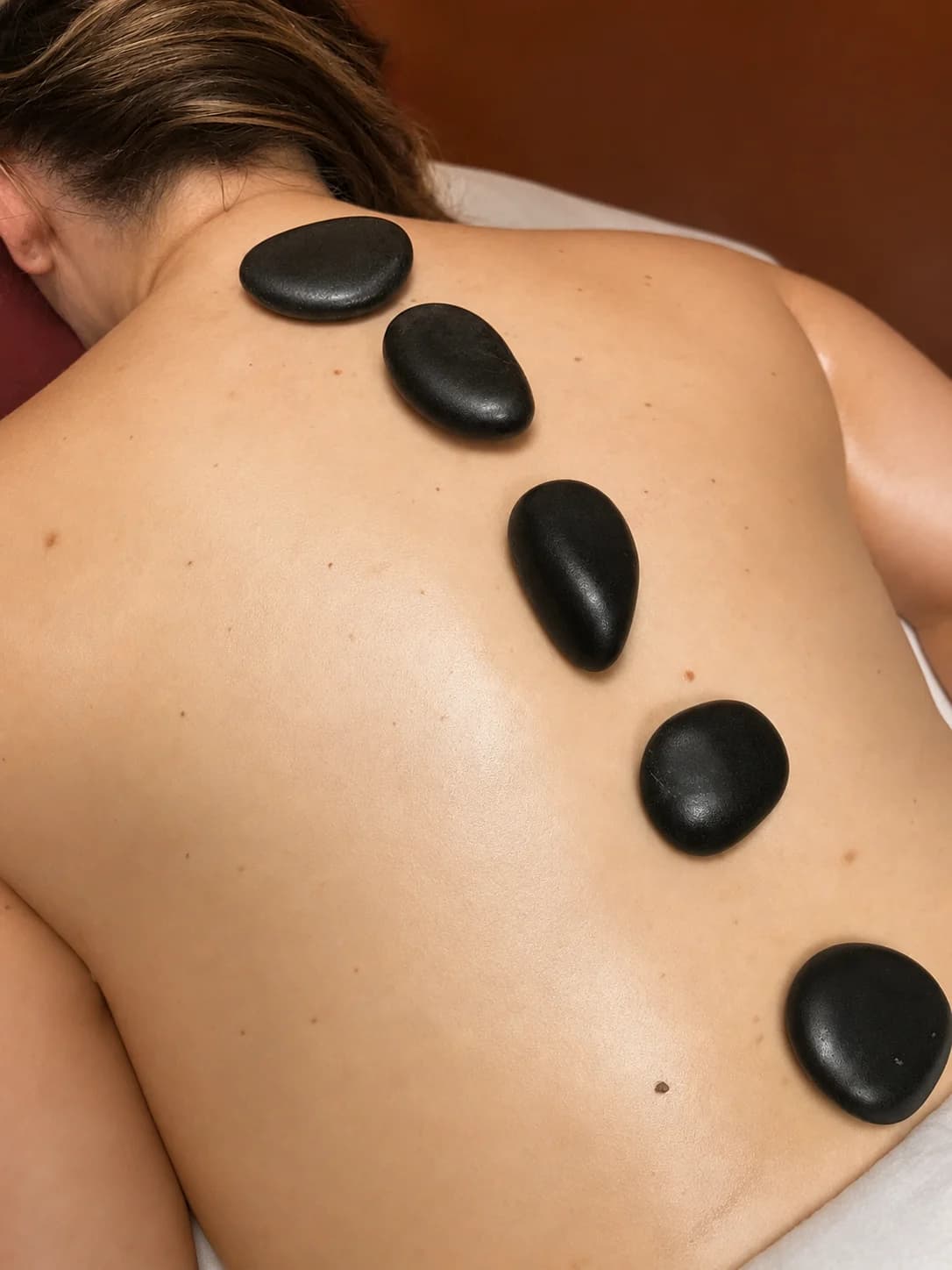 Hot stones placed along a client's back during treatment
