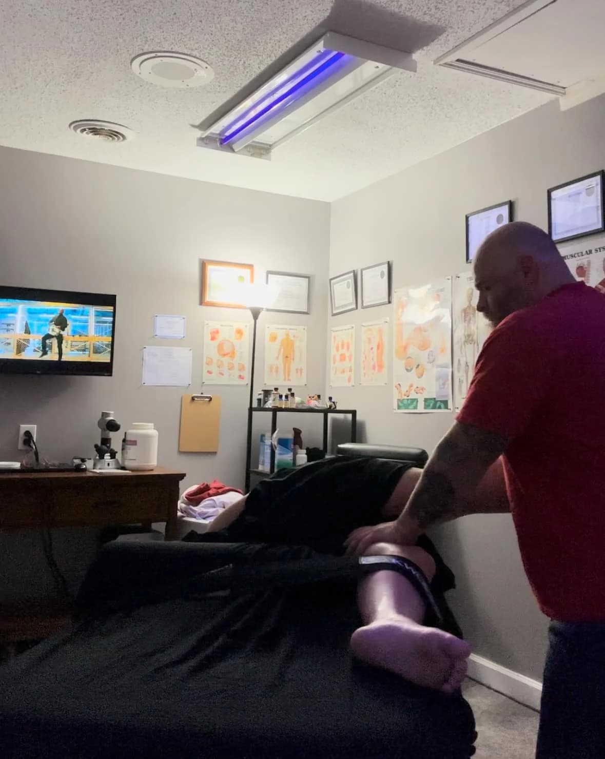 Chris Cox working through a client's lower leg during a sports-focused massage session