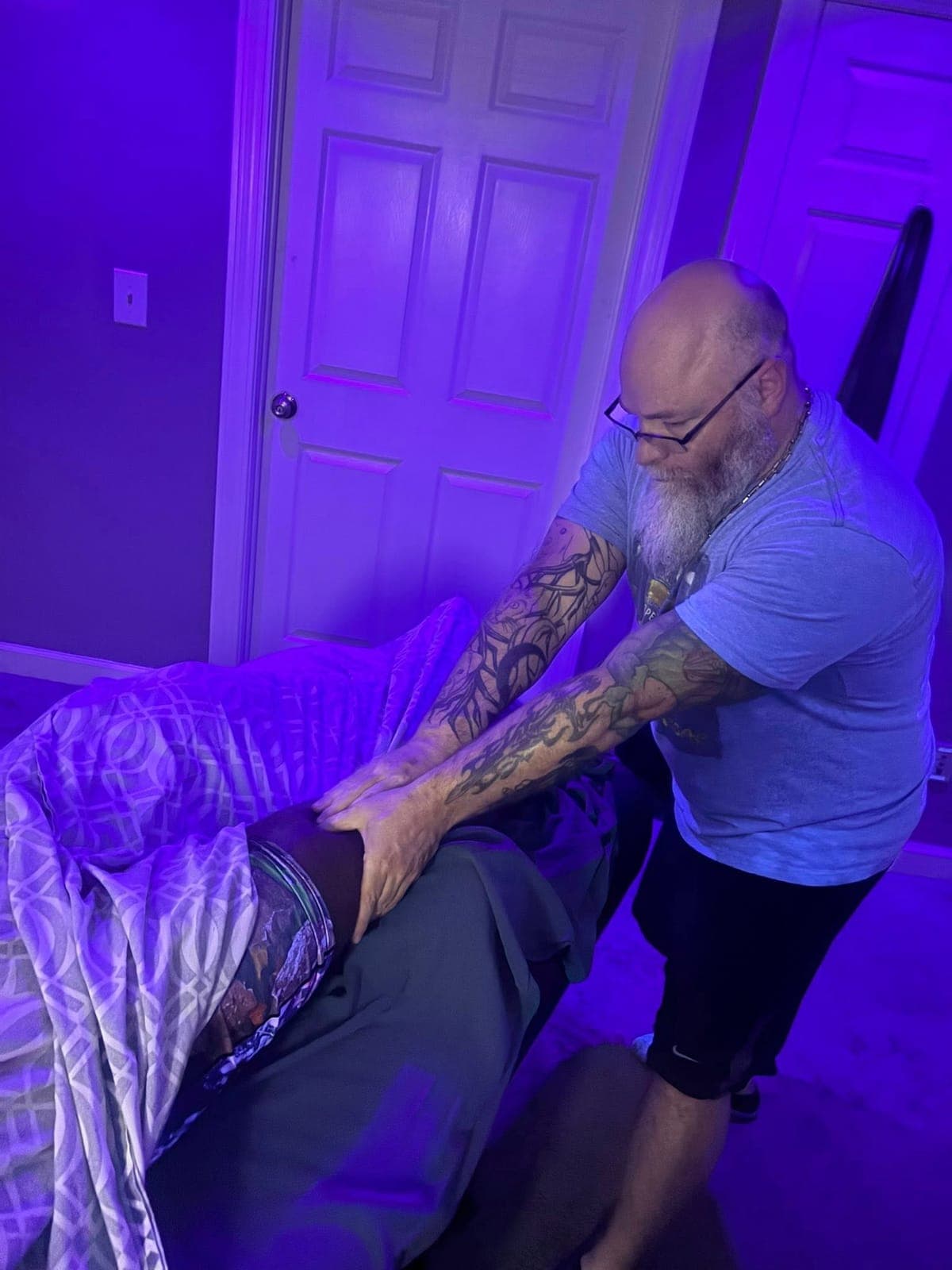 Chris Cox providing hands-on massage therapy in the treatment room