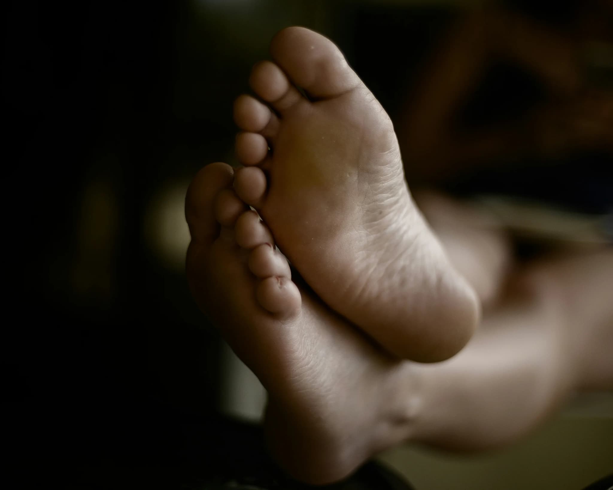 Close-up view of the soles and heels of two feet
